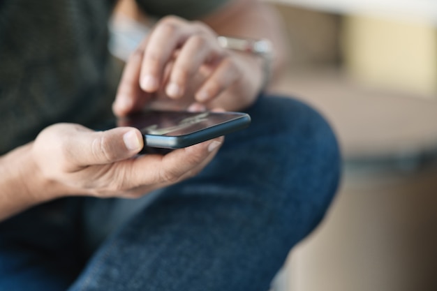 Closes-up man hand holding mobile smartphone.