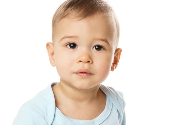 Closeuo shot of curious face of little boy in romper