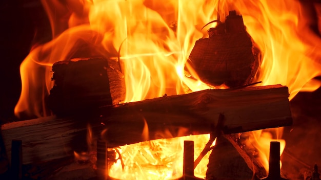 Closeup 4k footage of burning wooden logs in the firepalce at house