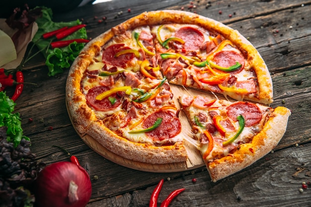 Closeup on appetizing hot pizza pepperoni with salami