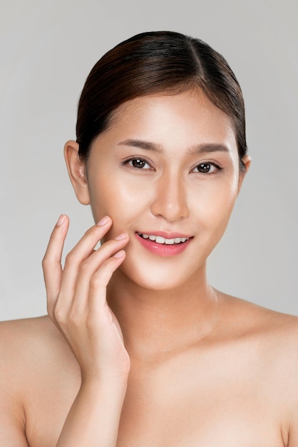 Closeup ardent young woman posing beauty gesture with clean fresh skin