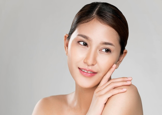 Closeup ardent young woman posing beauty gesture with clean fresh skin