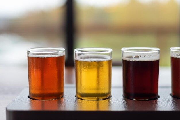 Photo closeup of artisanal craft beer flight in a variety of styles on a restaurant table