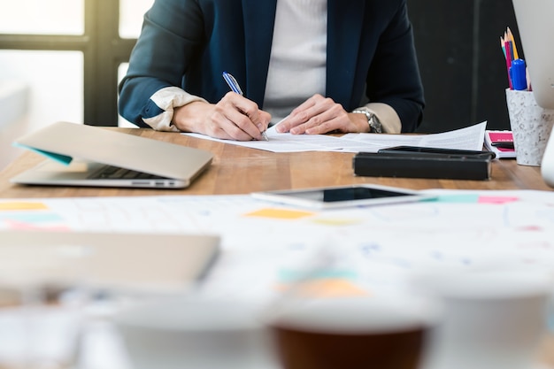 Closeup Asian Businesswoman hand writing in modern Office, People business concept