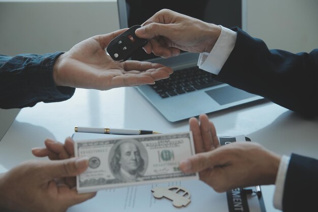 Closeup asian male people car salesman or sales manager offers to sell a car and explains and reads the terms of signing a car contract and insurance