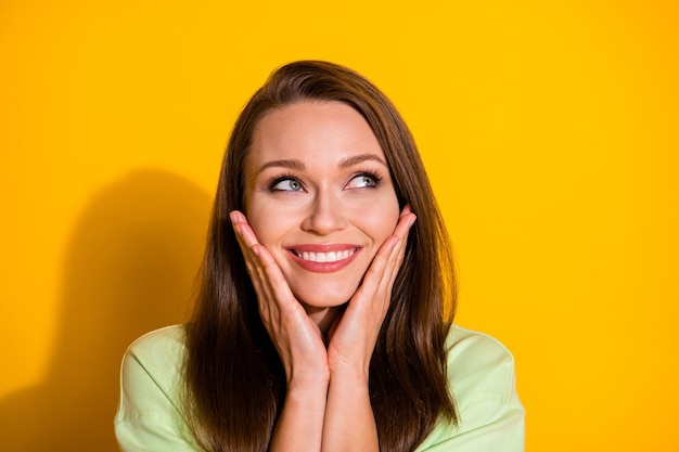 Closeup attractive funny lady arms on cheeks look side empty space