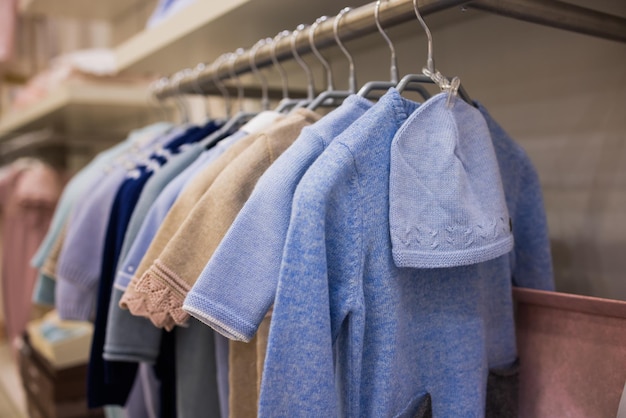 Closeup of baby clothes on rack in a flea market.