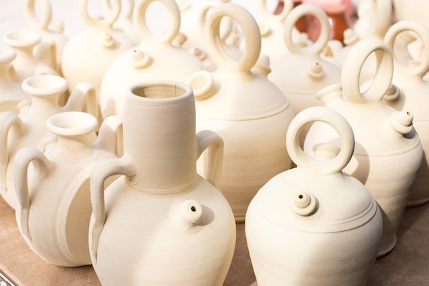 Closeup background of white clay jugs traditional Spanish home utensils