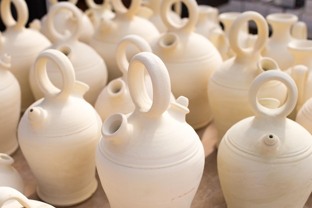 Closeup background of white clay jugs traditional Spanish home utensils