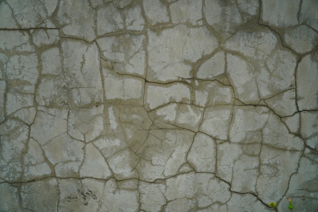 Closeup of badly fixed building facade wall covered with cracks