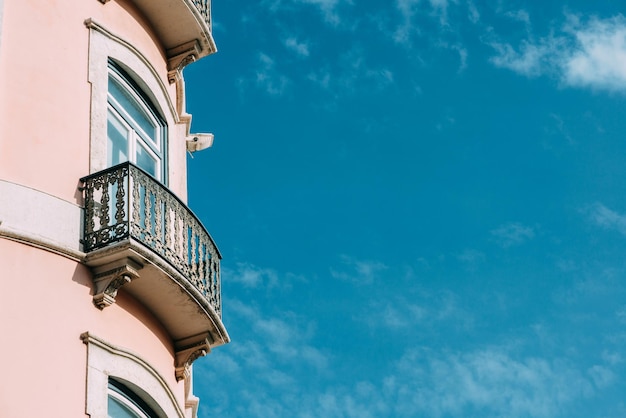 Closeup of a balcony of a pink building in Lisbon Portugal