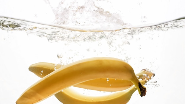 Closeup of bananas falling in clear water