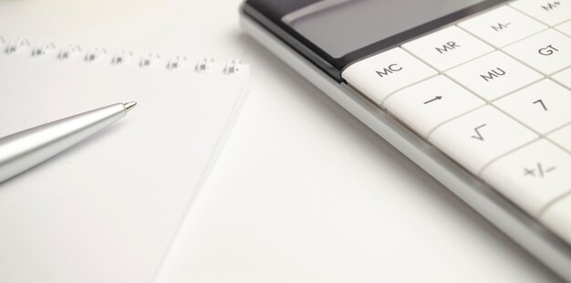 Closeup of bank statement calculator stack of coins and pen Bank employee making report Statistics data Financial bookkeeping and accounting concept