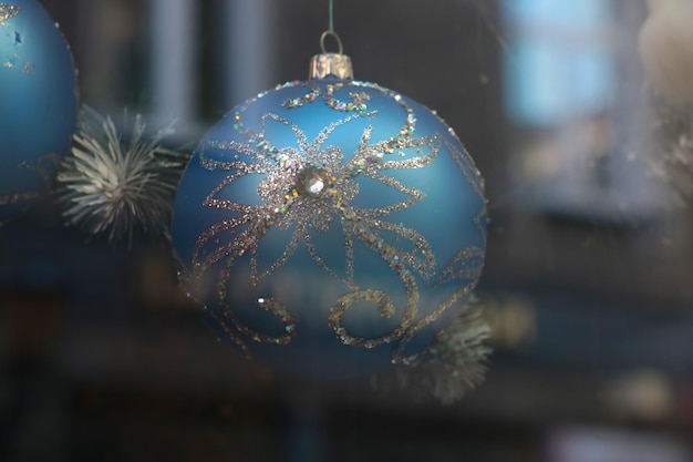 Closeup on a beautiful bright ball that hangs on a spruce Preparing for the New Year and Christmas Decorations