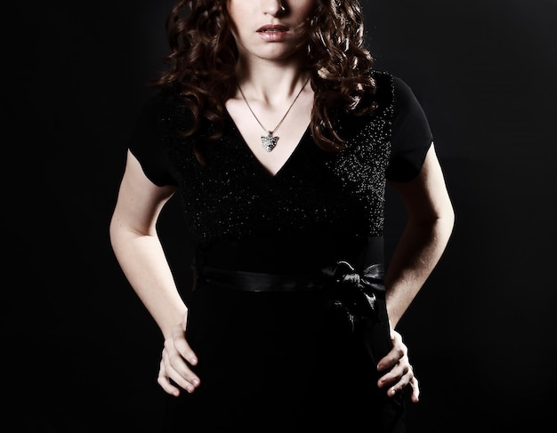 Closeup of beautiful young woman in evening black dress