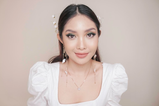 Closeup beauty face of Asian young model wearing ear accessories or ear cuff Green eyes makeup look Skincare beauty facial treatment spa female health concept