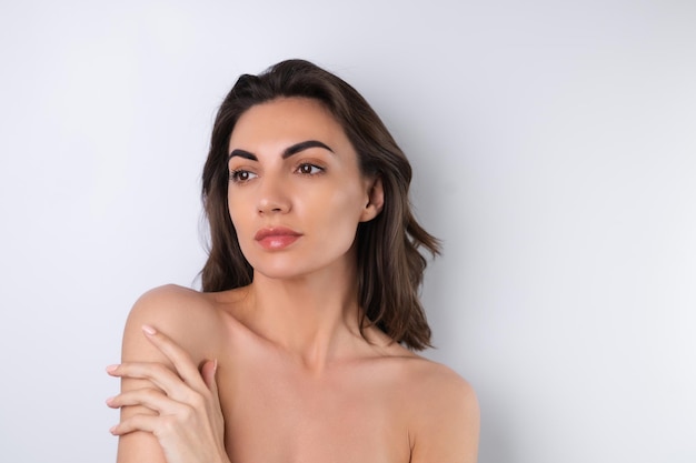 Closeup beauty portrait of a topless woman with perfect skin and natural makeup