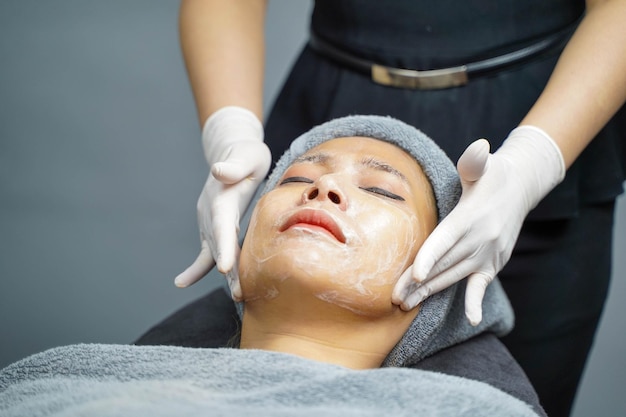 Closeup beauty woman making face spa and facial mask