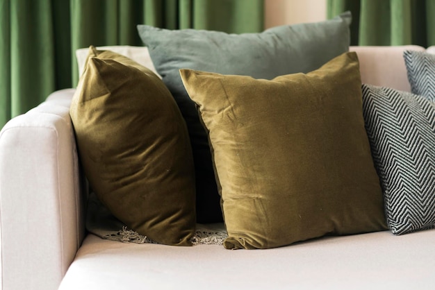 Closeup of beige earth tone pillow cushion set arrange on sofa couch in living room interior design home sweet home ideas conceptset of colour pillow arrange on sofa in living room home concept