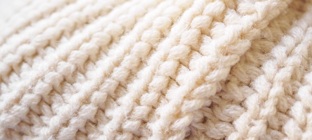 Closeup beige knitted woolen fabric texture background