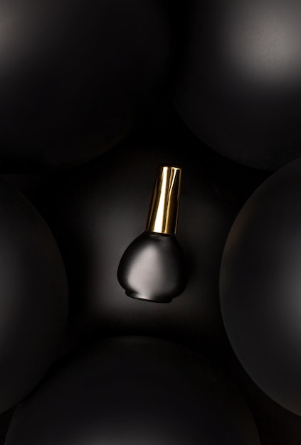 Closeup on a black jar with nail polish on a dark background