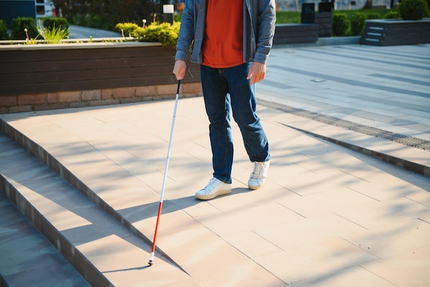 Closeup Of A Blind Man Standing With White Stick On Street