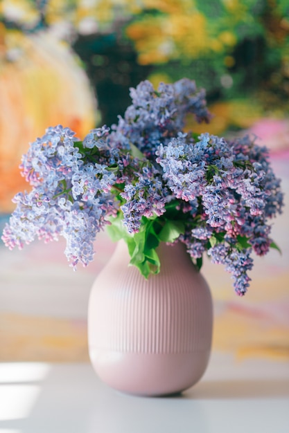 Closeup of blooming  lilac branches bouquet in vase