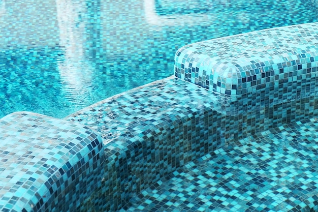 Closeup of a blue mosaic in a beautiful swimming pool Clear blue water in the pool Relax in the backyard of a country house