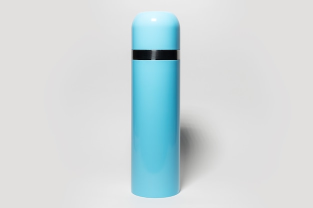 Closeup of blue steel thermos on grey studio background.