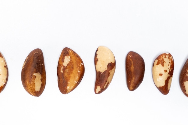 Photo closeup of brazil nuts on white background top view