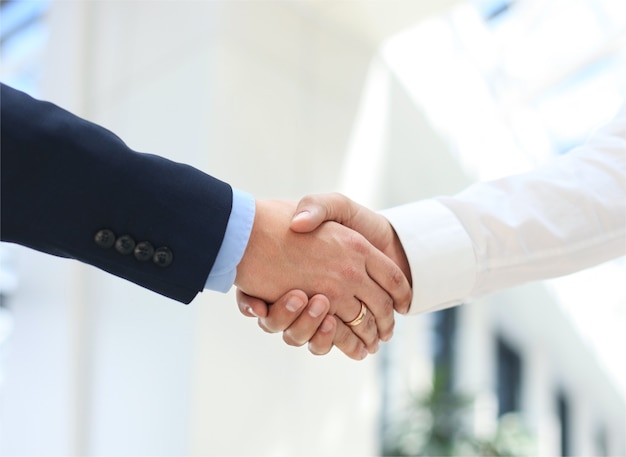 Closeup of a business hand shake between two colleagues