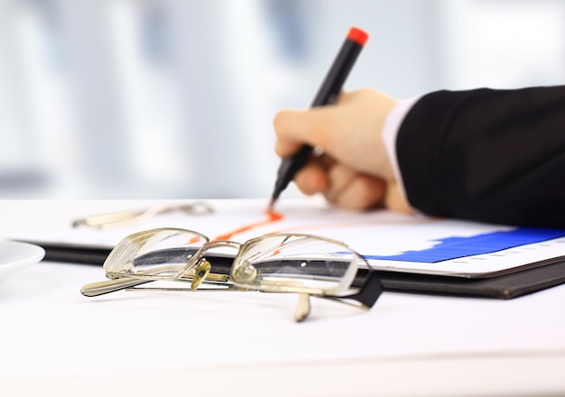 Closeup of business lady hand with pen signing a contract