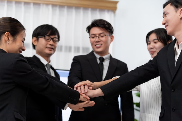 Closeup business team join hand stack together for harmony concept