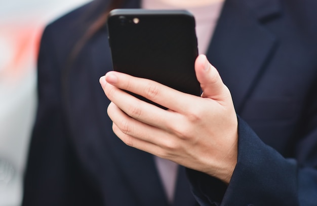 Closeup businesswomen using smartphone call phone