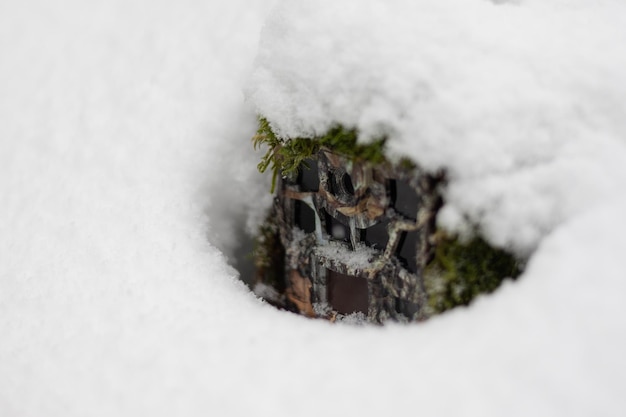 Closeup of camera trap covered in snow during wintertime