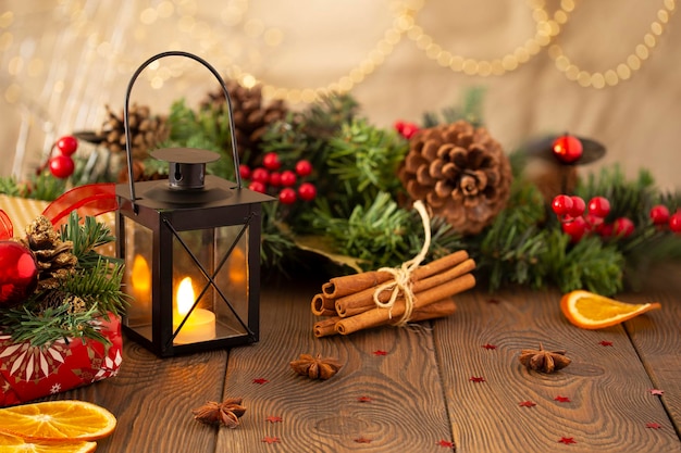 Closeup of a candlestick and a Christmas festive background with a Christmas tree decorated with decorative balls with golden lights on a wooden table copy space