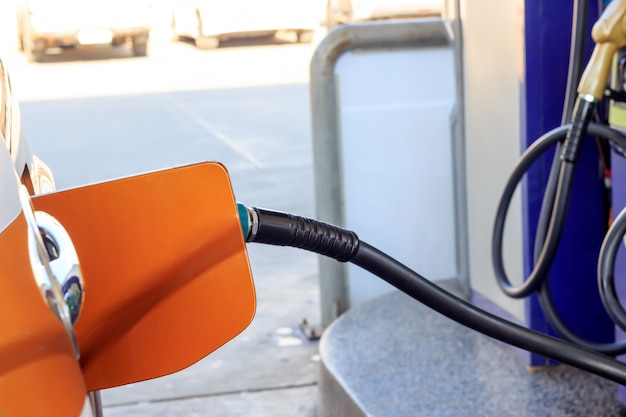 Closeup car refueling on a petrol station white car 