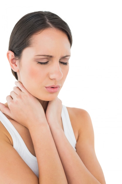 Closeup of a casual woman suffering from neck ache