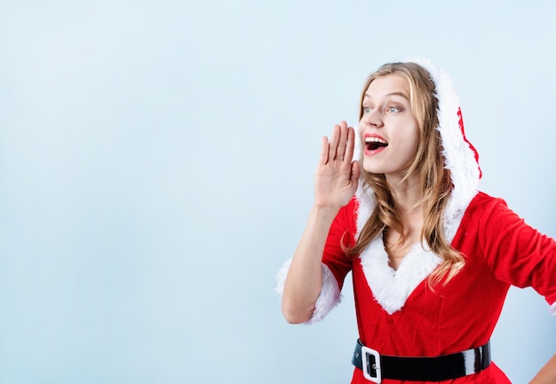 Closeup of caucasian happy woman wearing santa clothes calling someone