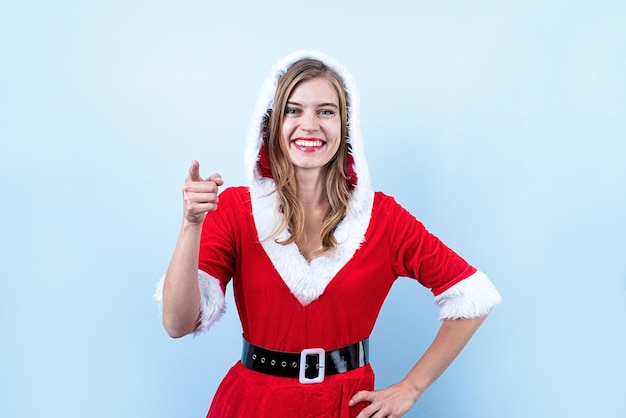 Closeup of caucasian happy woman wearing santa clothes pointing to the camera