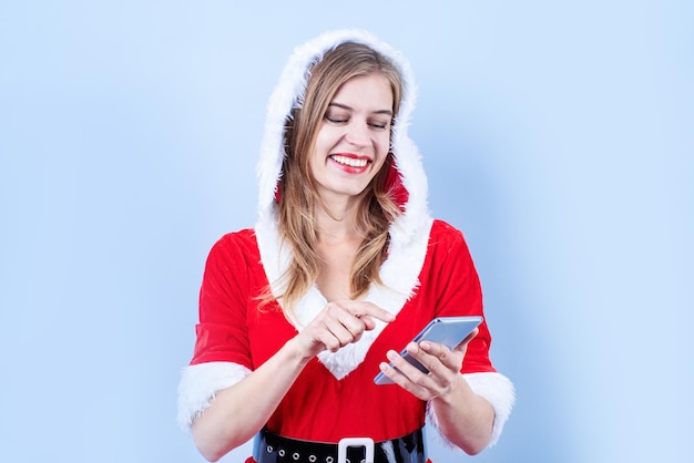 Closeup of caucasian happy woman wearing santa clothes using smartphone