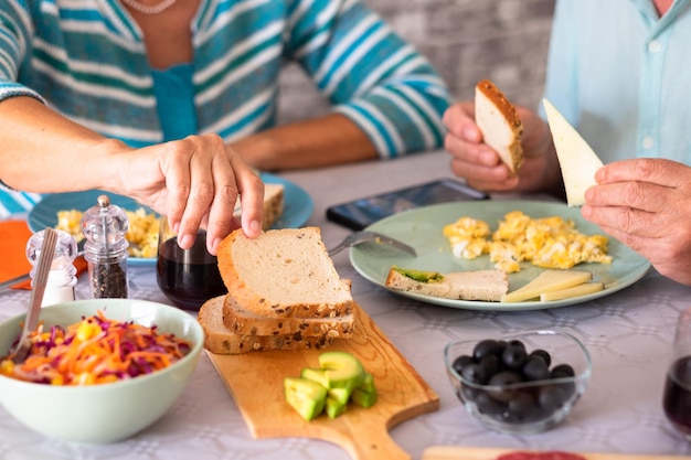 Closeup on caucasian senior couple sitting at the table having brunch at home