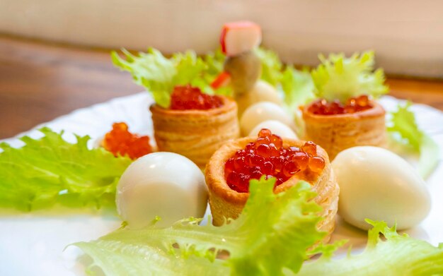 Closeup of caviar and cream cheese appetizer on crackers