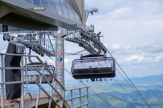 Closeup of a chairlift cab on the background of mountains