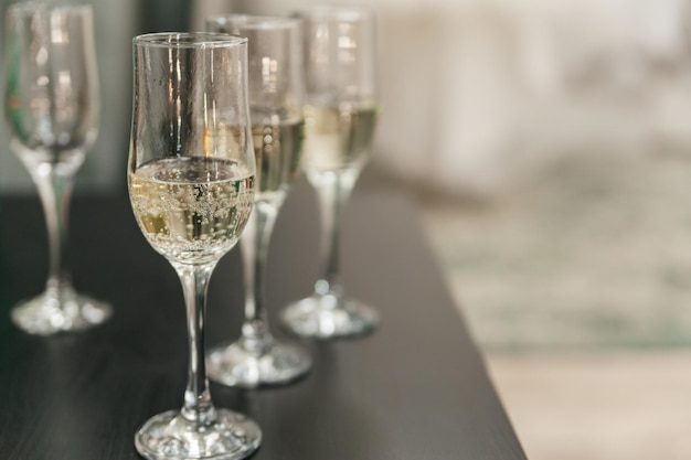 Closeup of champagne glasses in a row on the table Copy space