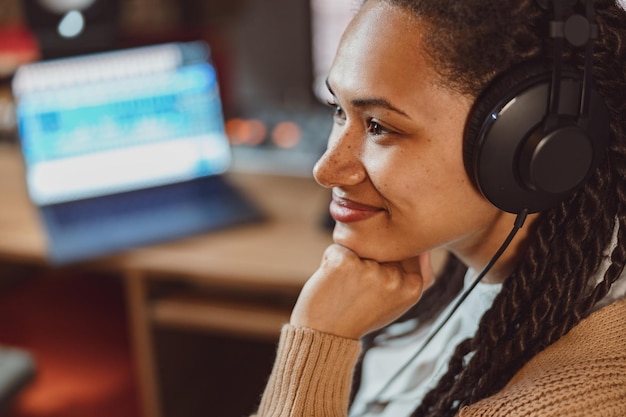 Closeup charming african woman songwriter sound engineer singer with headphones working on music