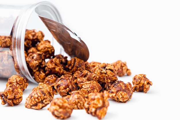 Closeup chocolate coated flavored popcorn on white wooden background