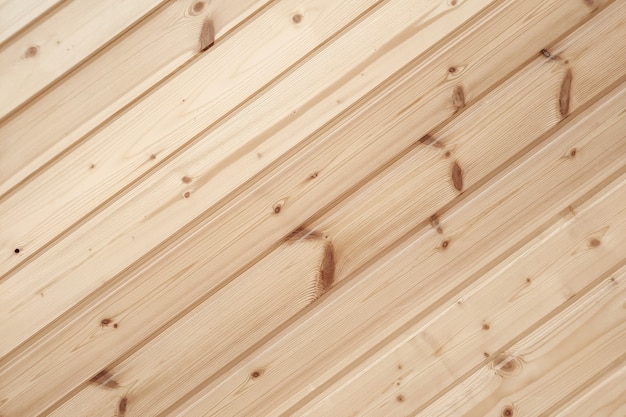 Closeup of clapboard wall Fragment of diagonal wooden planks Decorating material Wood texture