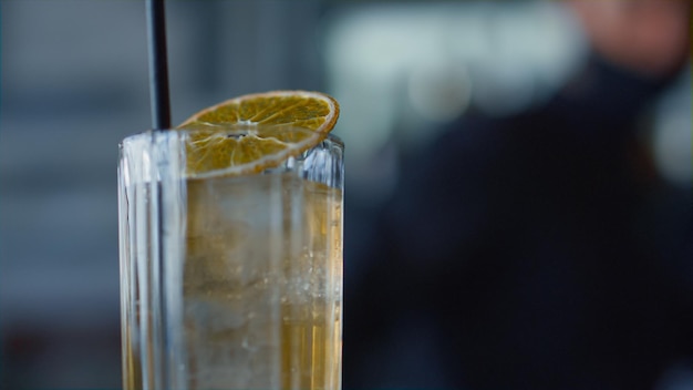 Closeup cocktail lemon glass indoors Silhouette bartender making beverages