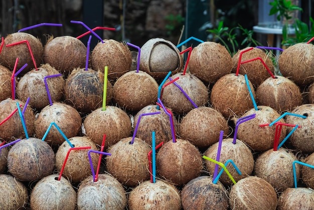 Closeup of a coconut on the display of a bar with freshly squeezed juice